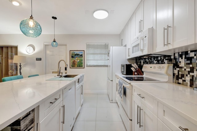 1232 W Club Dr W Unit D, Delray Beach, FL 33445 - kitchen featuring white appliances, a sink, baseboards, decorative backsplash, and white cabinetry
