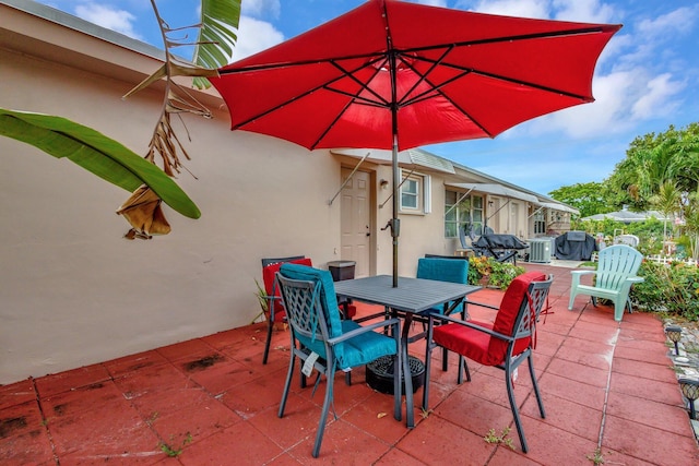 1232 W Club Dr W Unit D, Delray Beach, FL 33445 - view of patio / terrace with outdoor dining area and central air condition unit