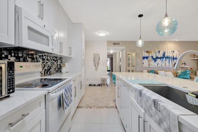 1232 W Club Dr W Unit D, Delray Beach, FL 33445 - kitchen with white appliances, white cabinets, pendant lighting, and light tile patterned flooring