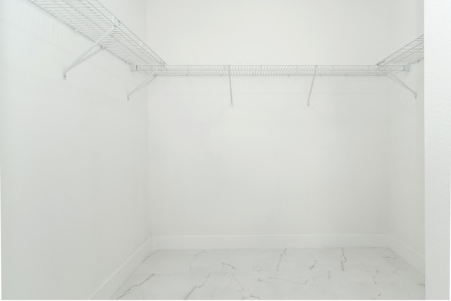 3810 29th St SW, Lehigh Acres, FL 33976 - walk in closet featuring marble look tile flooring