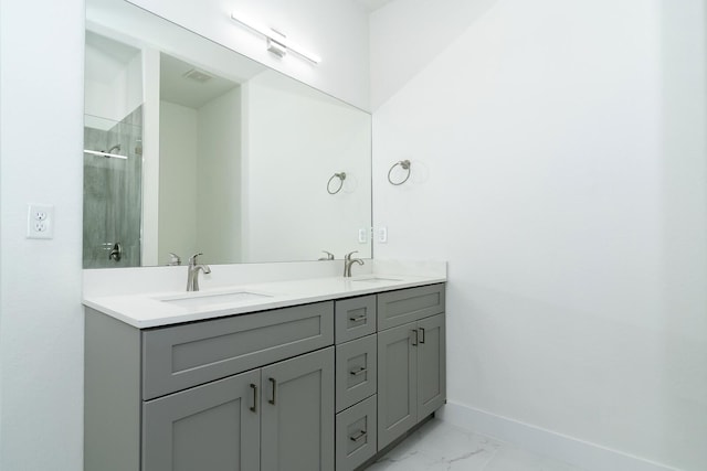 3810 29th St SW, Lehigh Acres, FL 33976 - full bath with marble look tiles, baseboards, double vanity, and a shower