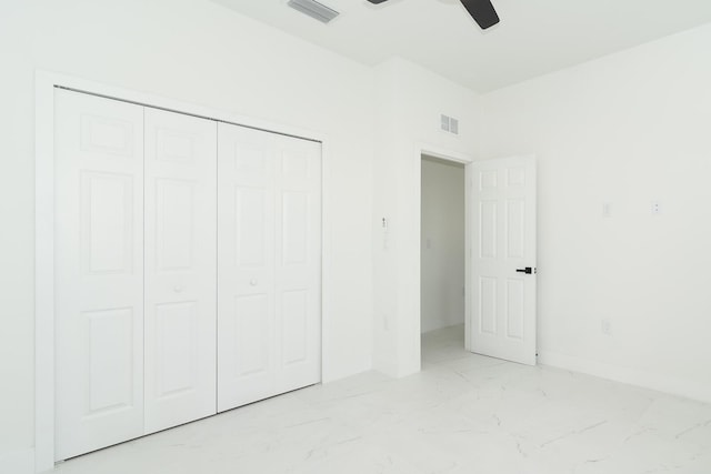 3810 29th St SW, Lehigh Acres, FL 33976 - unfurnished bedroom with light marble finish flooring, a closet, a ceiling fan, and baseboards