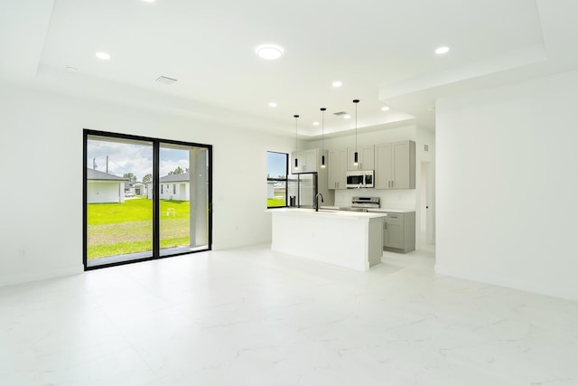3810 29th St SW, Lehigh Acres, FL 33976 - unfurnished living room with a tray ceiling, recessed lighting, and a sink
