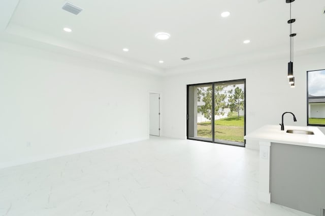 3810 29th St SW, Lehigh Acres, FL 33976 - unfurnished living room with a sink, a raised ceiling, recessed lighting, and light marble finish flooring