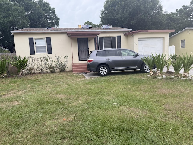 803 Texas Ct, Fort Pierce, FL 34950 - single story home featuring stucco siding, an attached garage, and a front yard