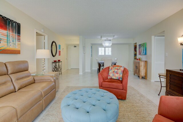 400 Ocean Trail Way Unit 707, Jupiter, FL 33477 - living area with light tile patterned flooring, a textured ceiling, and baseboards