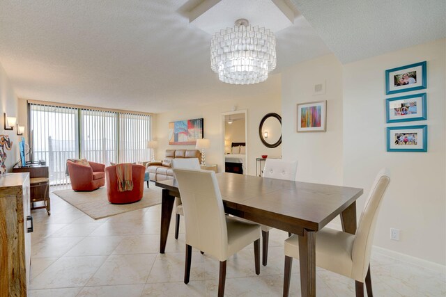 400 Ocean Trail Way Unit 707, Jupiter, FL 33477 - dining room with a chandelier and a textured ceiling