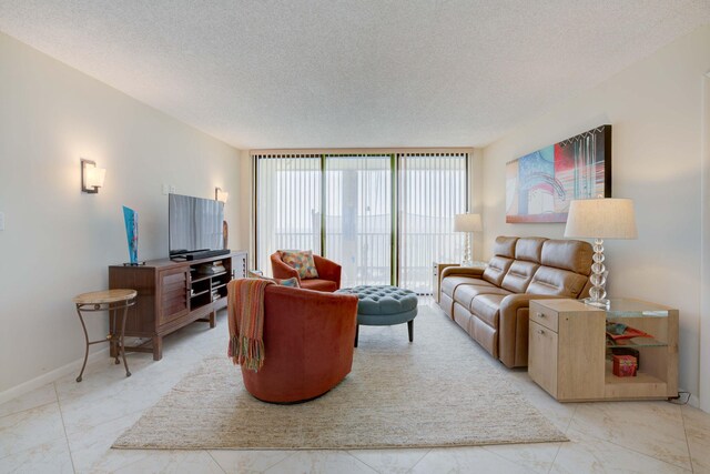 400 Ocean Trail Way Unit 707, Jupiter, FL 33477 - living area featuring light marble finish flooring, a textured ceiling, expansive windows, and baseboards