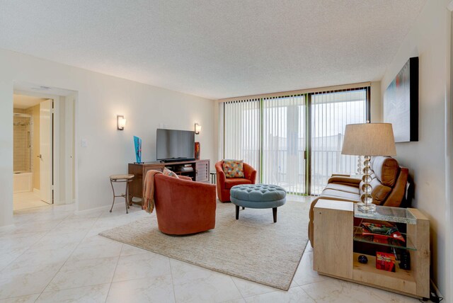400 Ocean Trail Way Unit 707, Jupiter, FL 33477 - living area with marble finish floors and a textured ceiling