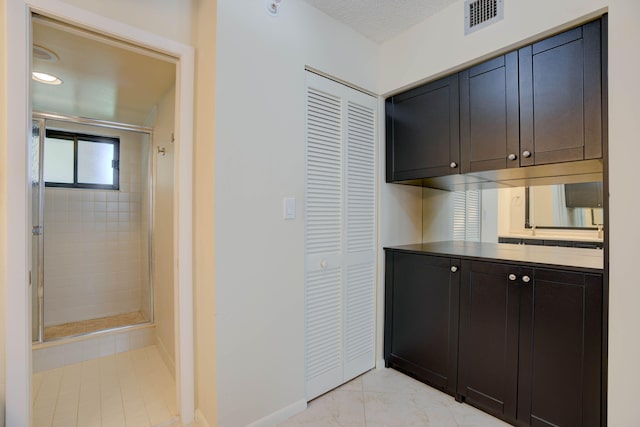 400 Ocean Trail Way Unit 707, Jupiter, FL 33477 - full bath with a stall shower, vanity, baseboards, a closet, and marble finish flooring