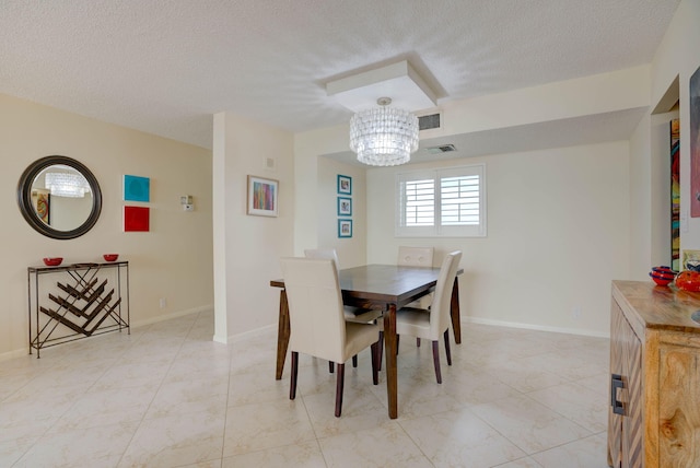 400 Ocean Trail Way Unit 707, Jupiter, FL 33477 - dining space with a chandelier, a textured ceiling, and baseboards