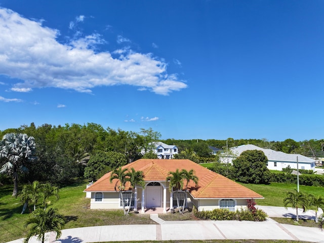 17477 69th St N, Loxahatchee, FL 33470 - mediterranean / spanish-style house with a tiled roof, a front yard, and stucco siding