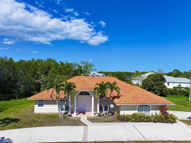 17477 69th St N, Loxahatchee, FL 33470 - mediterranean / spanish-style home with a tile roof, stucco siding, and a front yard
