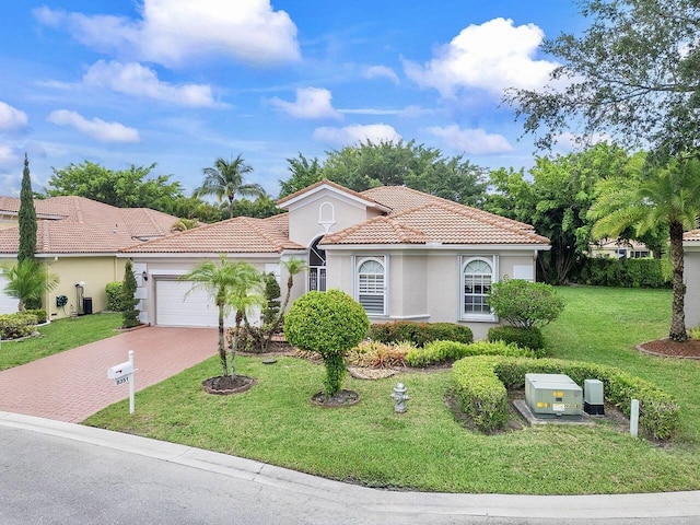 8351 Mastic Cay, West Palm Beach, FL 33411 - mediterranean / spanish-style home featuring stucco siding, a tile roof, decorative driveway, an attached garage, and a front lawn