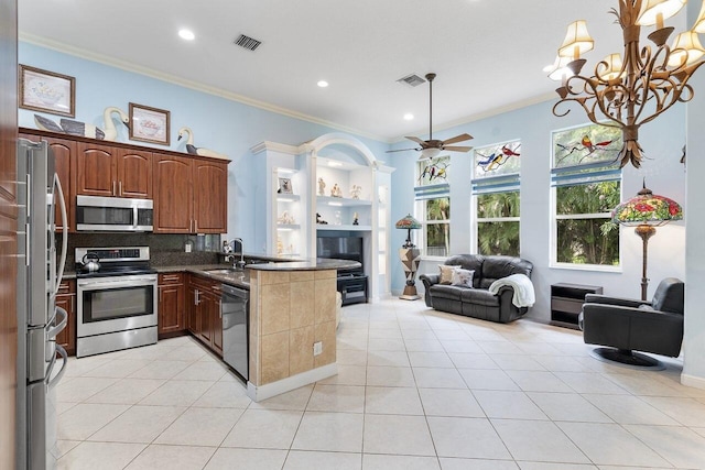 8351 Mastic Cay, West Palm Beach, FL 33411 - kitchen with stainless steel appliances, open floor plan, crown molding, a peninsula, and a sink