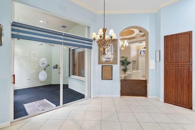 8351 Mastic Cay, West Palm Beach, FL 33411 - empty room with a chandelier, ornamental molding, arched walkways, light tile patterned floors, and baseboards