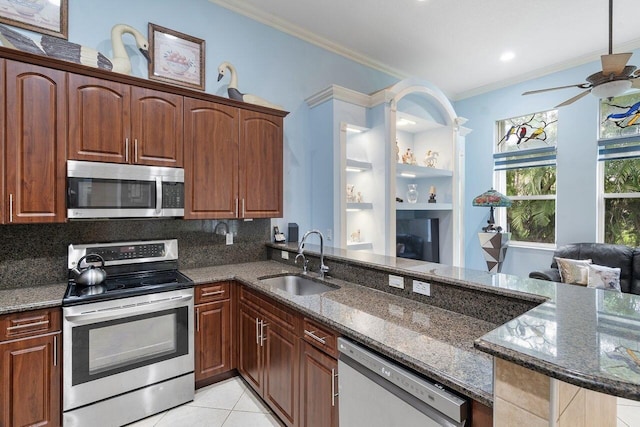 8351 Mastic Cay, West Palm Beach, FL 33411 - kitchen with appliances with stainless steel finishes, a sink, crown molding, ceiling fan, and dark stone countertops