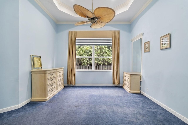 8351 Mastic Cay, West Palm Beach, FL 33411 - spare room featuring a raised ceiling, ornamental molding, dark colored carpet, a ceiling fan, and baseboards