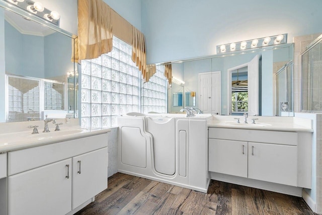 8351 Mastic Cay, West Palm Beach, FL 33411 - full bathroom featuring two vanities, wood finished floors, a stall shower, and crown molding