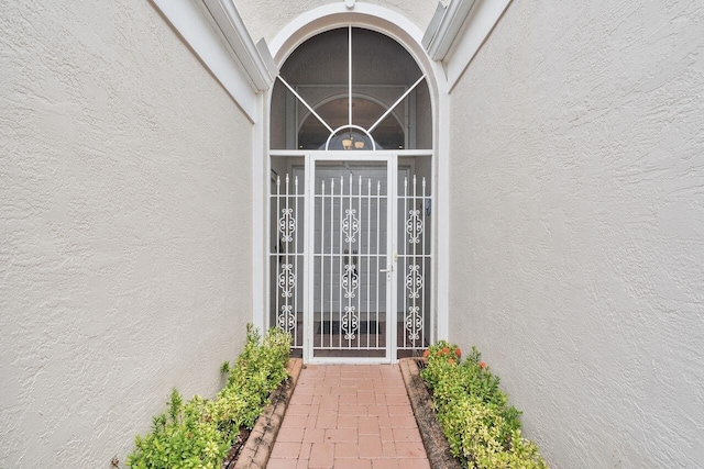 8351 Mastic Cay, West Palm Beach, FL 33411 - doorway to property with stucco siding