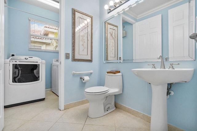 8351 Mastic Cay, West Palm Beach, FL 33411 - bathroom with washing machine and clothes dryer, toilet, baseboards, tile patterned floors, and ornamental molding