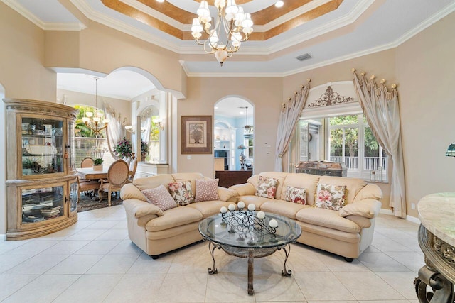 8351 Mastic Cay, West Palm Beach, FL 33411 - living room featuring a chandelier, arched walkways, a raised ceiling, light tile patterned floors, and ornamental molding