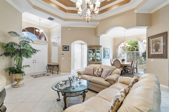 8351 Mastic Cay, West Palm Beach, FL 33411 - tiled living room featuring a chandelier, a towering ceiling, ornamental molding, arched walkways, and plenty of natural light