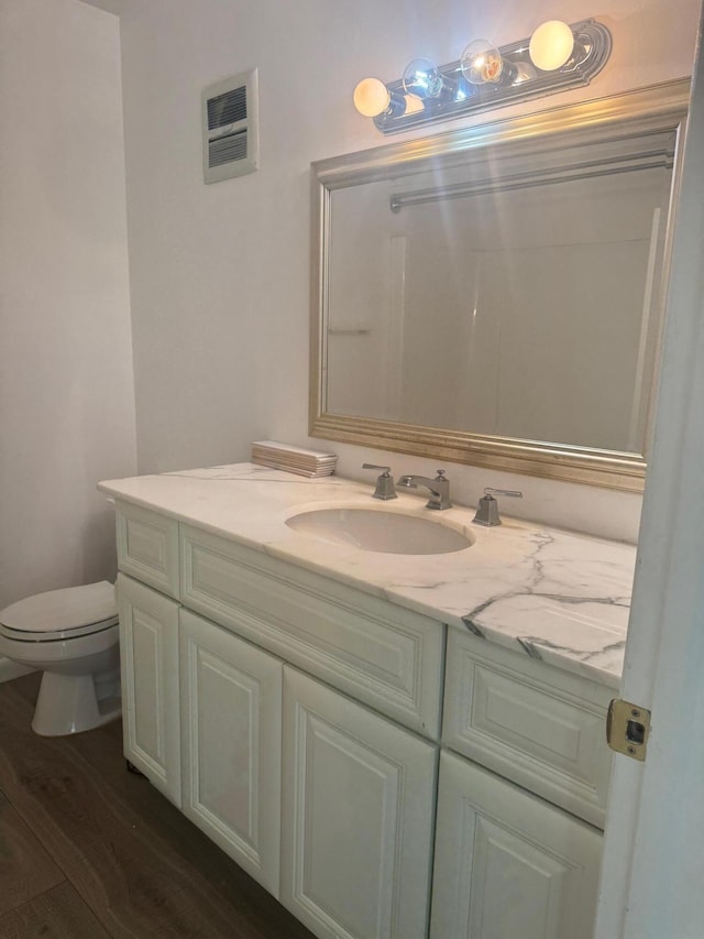 10789 N Military Trl Unit 3, Palm Beach Gardens, FL 33410 - bathroom featuring vanity, toilet, and wood finished floors