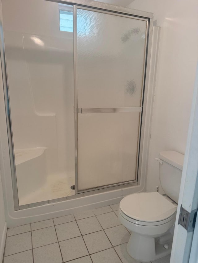 10789 N Military Trl Unit 3, Palm Beach Gardens, FL 33410 - bathroom featuring tile patterned flooring, a stall shower, and toilet