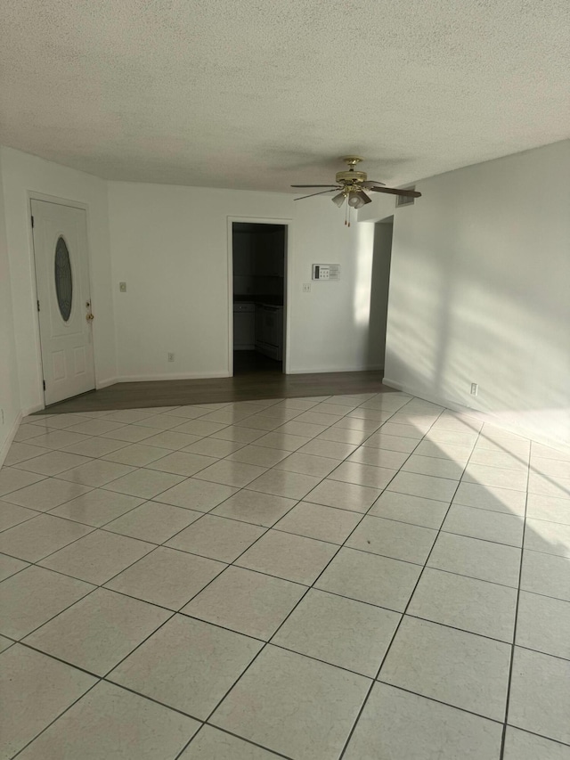 10789 N Military Trl Unit 3, Palm Beach Gardens, FL 33410 - unfurnished room featuring a textured ceiling, ceiling fan, light tile patterned floors, and baseboards