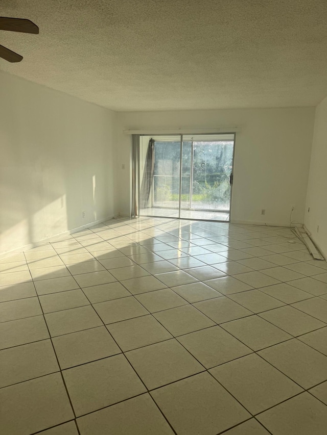 10789 N Military Trl Unit 3, Palm Beach Gardens, FL 33410 - unfurnished room featuring light tile patterned floors, a ceiling fan, a textured ceiling, and baseboards