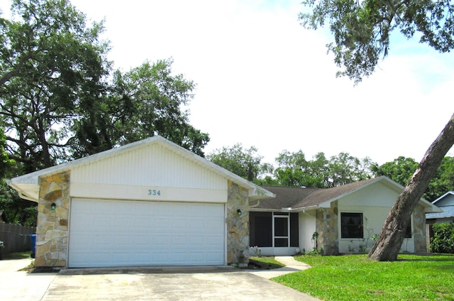 334 Brookedge Ter, Sebastian, FL 32958 - single story home featuring stone siding, driveway, an attached garage, and a front lawn