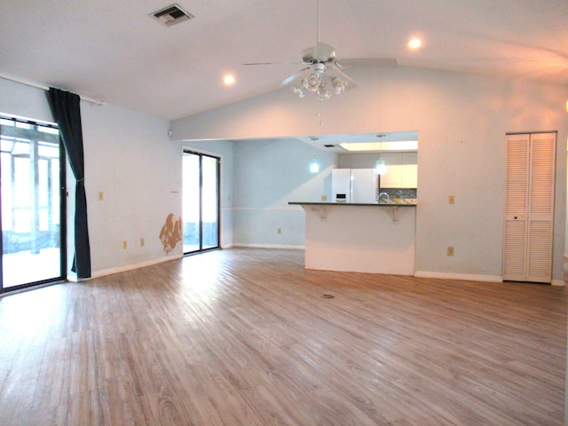 334 Brookedge Ter, Sebastian, FL 32958 - unfurnished living room with ceiling fan, baseboards, wood finished floors, vaulted ceiling, and recessed lighting