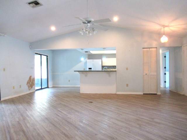 334 Brookedge Ter, Sebastian, FL 32958 - unfurnished living room with lofted ceiling, wood finished floors, a ceiling fan, baseboards, and recessed lighting
