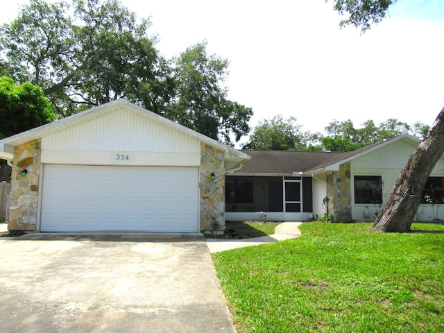 334 Brookedge Ter, Sebastian, FL 32958 - ranch-style house featuring stone siding, concrete driveway, a front lawn, and a garage