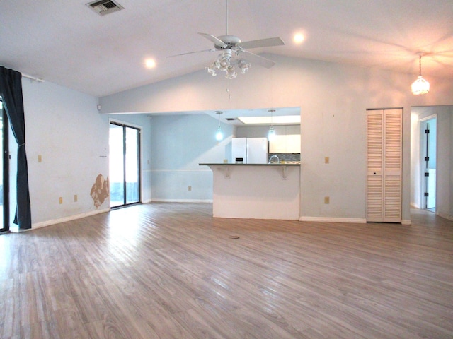 334 Brookedge Ter, Sebastian, FL 32958 - unfurnished living room with lofted ceiling, ceiling fan, wood finished floors, and baseboards