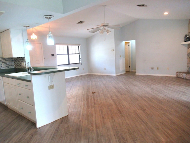 334 Brookedge Ter, Sebastian, FL 32958 - kitchen featuring white cabinetry, a sink, wood finished floors, ceiling fan, and vaulted ceiling