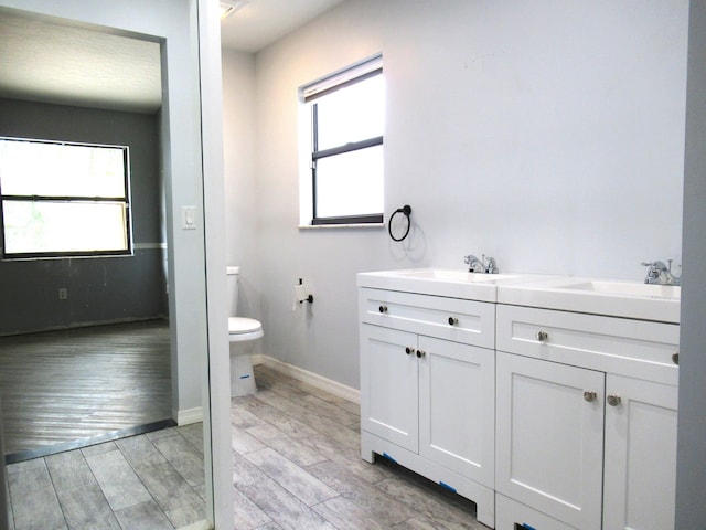 334 Brookedge Ter, Sebastian, FL 32958 - bathroom with toilet, double vanity, baseboards, and wood finished floors