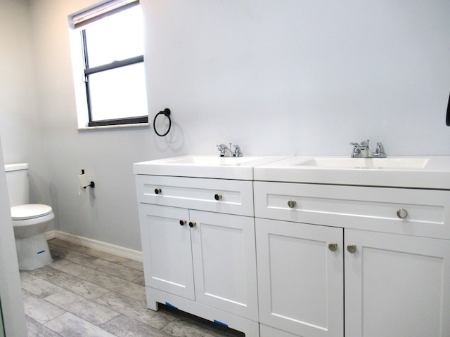 334 Brookedge Ter, Sebastian, FL 32958 - bathroom with double vanity, toilet, and baseboards