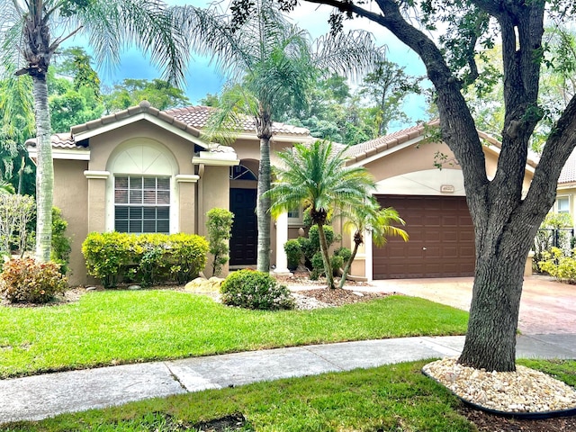 4920 Swans Ln, Coconut Creek, FL 33073 - mediterranean / spanish house featuring stucco siding, an attached garage, a tiled roof, and a front yard