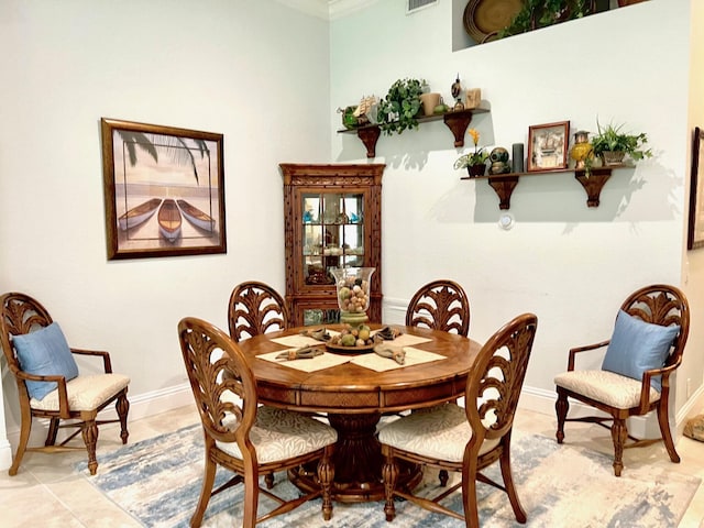 4920 Swans Ln, Coconut Creek, FL 33073 - dining room featuring baseboards, light tile patterned floors, and crown molding