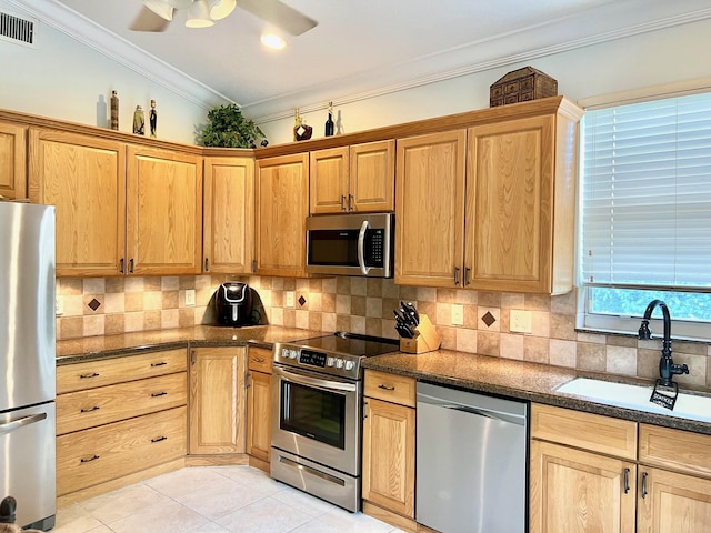 4920 Swans Ln, Coconut Creek, FL 33073 - kitchen with stainless steel appliances, a sink, light tile patterned floors, tasteful backsplash, and dark stone countertops