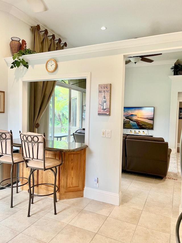 4920 Swans Ln, Coconut Creek, FL 33073 - bar area featuring light tile patterned floors, crown molding, ceiling fan, and baseboards