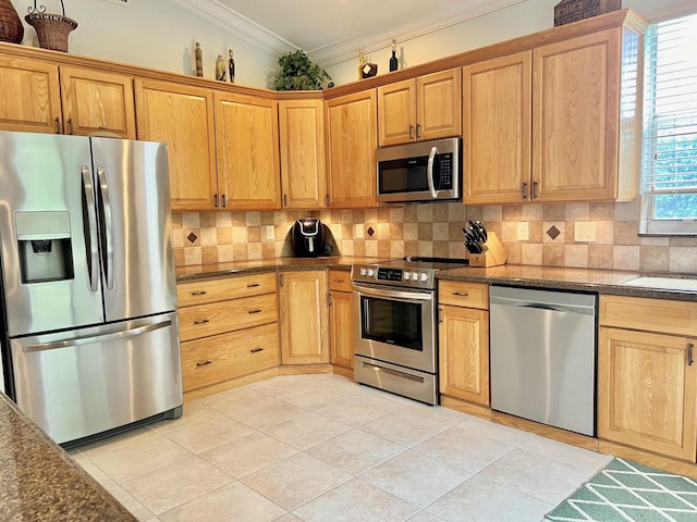 4920 Swans Ln, Coconut Creek, FL 33073 - kitchen with appliances with stainless steel finishes, crown molding, decorative backsplash, light tile patterned floors, and dark stone countertops