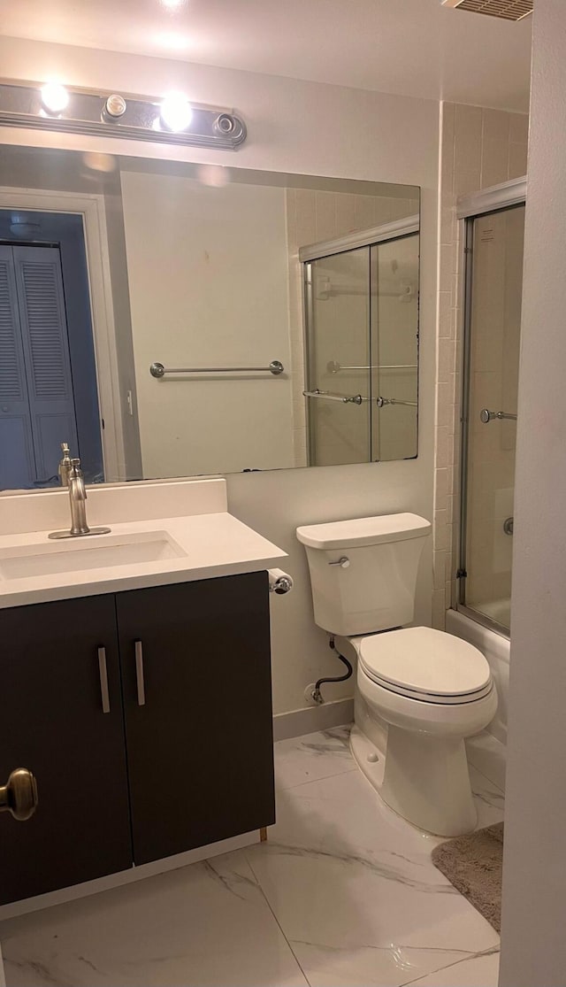 4988 Sable Pine Cir Unit B2, West Palm Beach, FL 33417 - bathroom with vanity, toilet, marble look tile flooring, and enclosed tub / shower combo