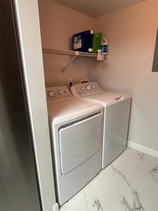 4988 Sable Pine Cir Unit B2, West Palm Beach, FL 33417 - washroom featuring washer and clothes dryer, marble look tile flooring, and baseboards