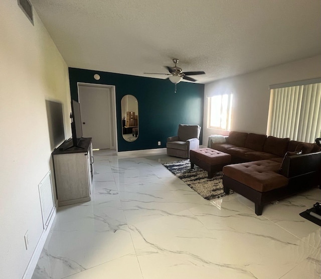 4988 Sable Pine Cir Unit B2, West Palm Beach, FL 33417 - living room with marble finish flooring, a textured ceiling, ceiling fan, and baseboards