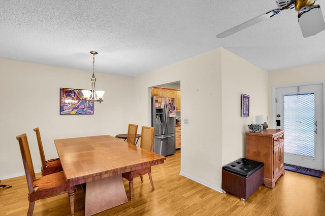 5229 Lakefront Blvd Unit A, Delray Beach, FL 33484 - dining area featuring a textured ceiling, light wood finished floors, and a chandelier