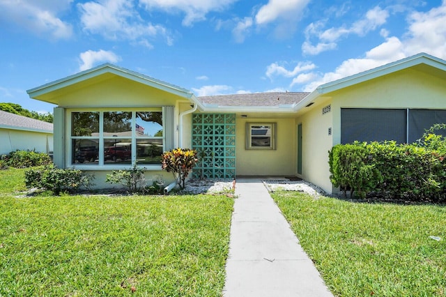 5229 Lakefront Blvd Unit A, Delray Beach, FL 33484 - ranch-style house with a front yard, stucco siding, and a shingled roof
