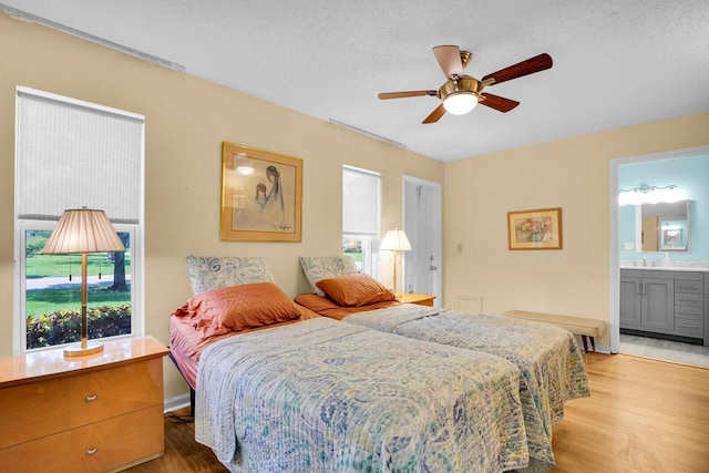 5229 Lakefront Blvd Unit A, Delray Beach, FL 33484 - bedroom with light wood finished floors, ensuite bath, and ceiling fan